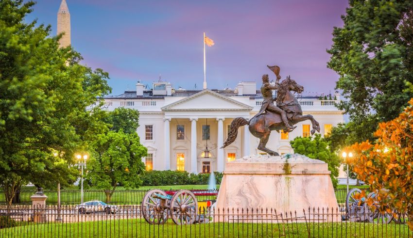 A statue of a horse in front of the white house.