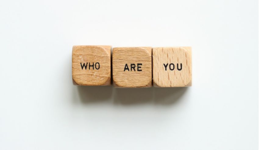 Three wooden blocks with the word who are you on them.