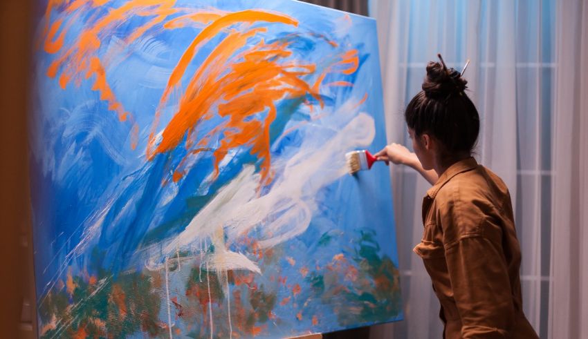 A woman painting on an easel.
