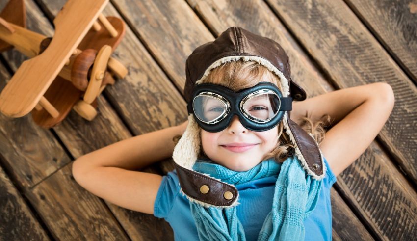 A little girl wearing a pilot's hat and goggles.