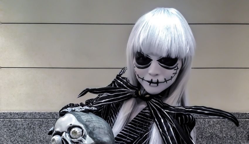 A woman dressed as a skeleton holding a skull.