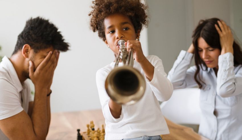 A family playing chess with a child playing a trumpet.