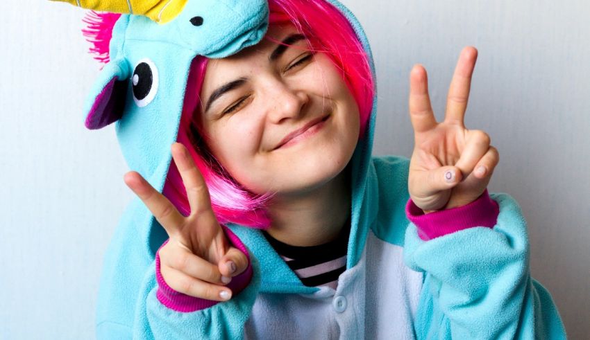 A girl in a unicorn costume making a peace sign.