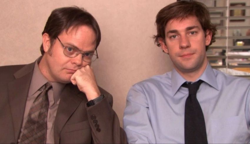 Two men sitting next to each other in an office.