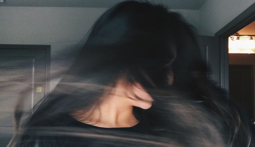 A blurry image of a woman with long hair.