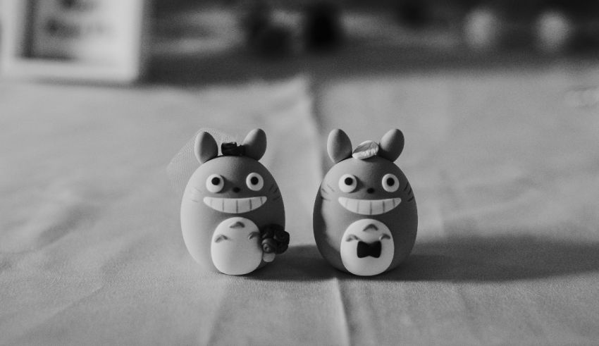 Two totoro figurines on a table.