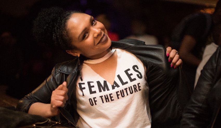 A woman wearing a t - shirt that says females of the future.