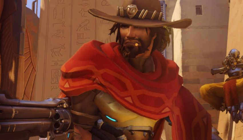 A man in a cowboy hat is holding a gun.