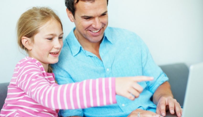 A man and a girl using a laptop at home.