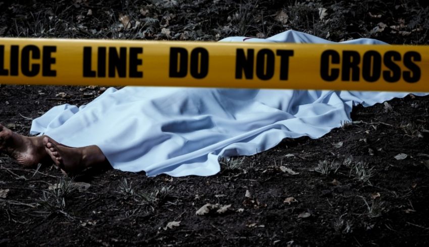 A dead body laying on the ground with a police tape.