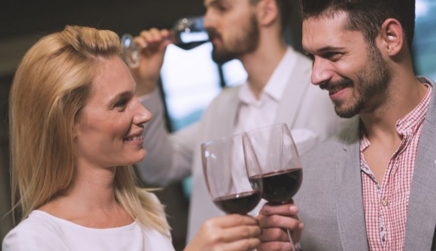 A group of people toasting wine glasses in a restaurant.