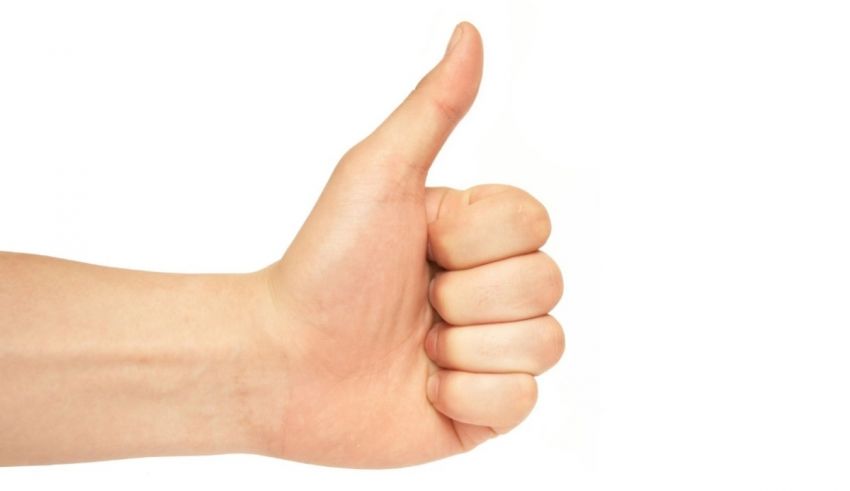 A hand giving a thumbs up on a white background.