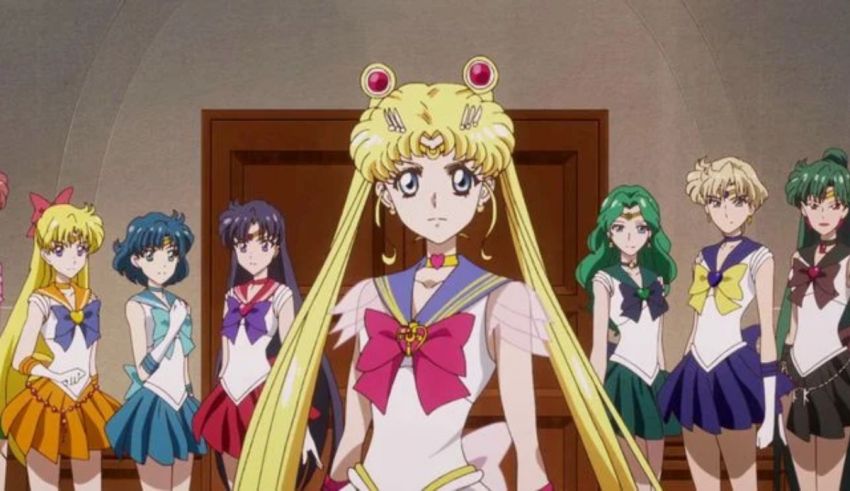 A group of sailor moon characters standing next to each other.