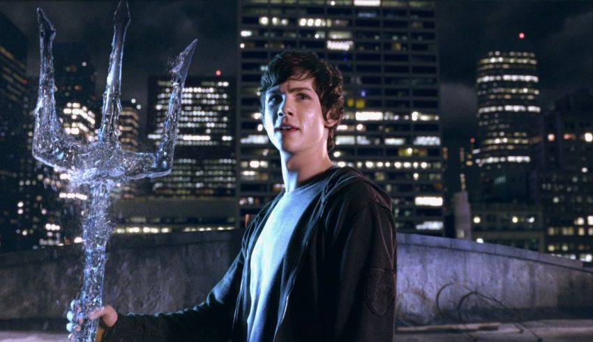 A young man holding a sword in front of a city.