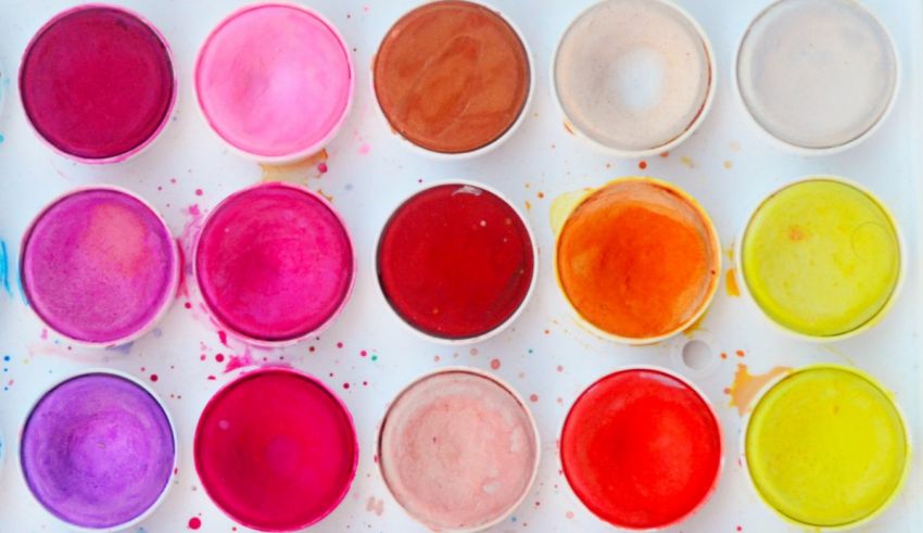 A variety of different colored paints on a white background.