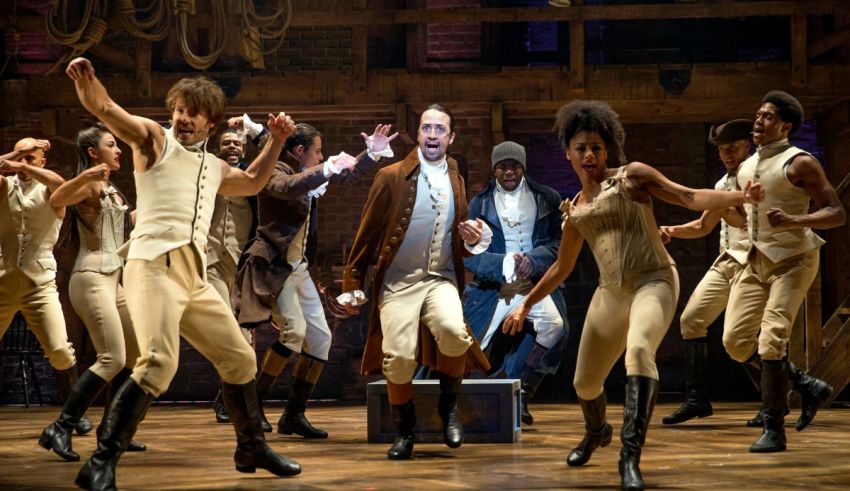 A group of people dancing on stage in hamilton.