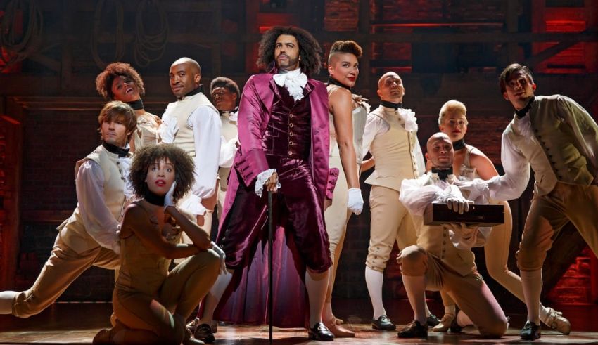 A group of people posing in front of a stage.