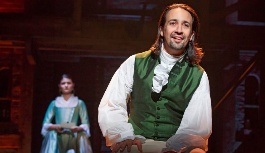 A man in a green vest and a woman in a green dress.