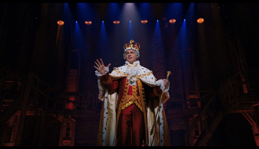 A man dressed in a king's costume on stage.