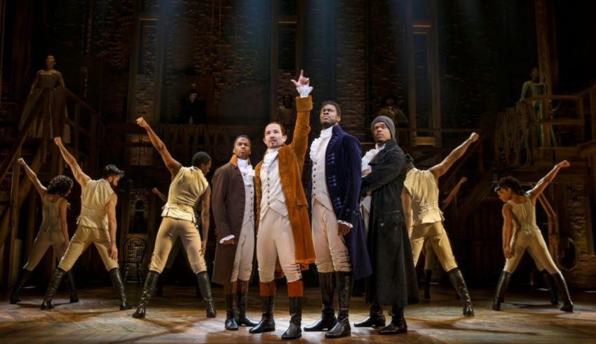 The cast of hamilton in a stage performance.