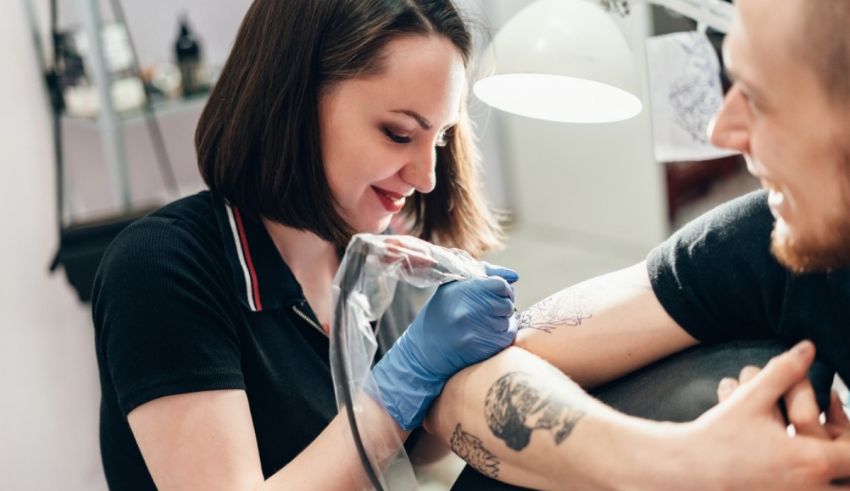 A woman getting a tattoo at a tattoo shop.