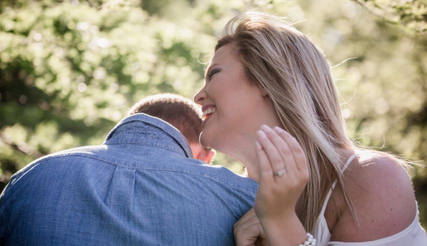 A man and woman hugging each other during their engagement session.