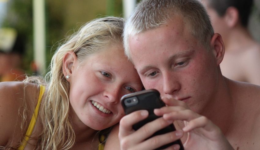 A man and a woman looking at a cell phone.