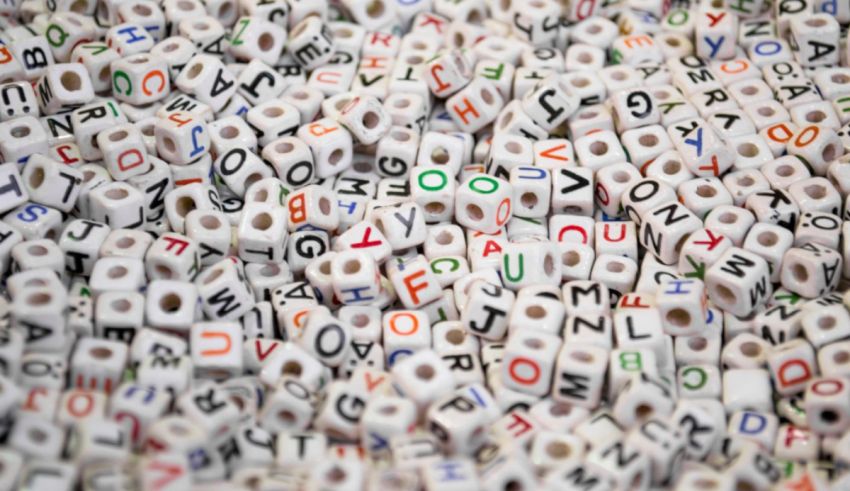 A pile of beads with different letters on them.
