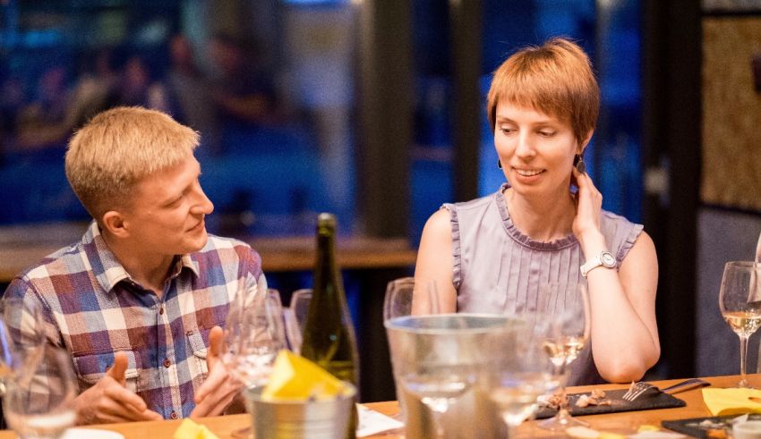 A man and woman sitting at a table in a restaurant.