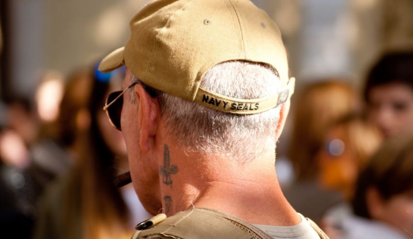 A man in a hat with a tattoo on his back.