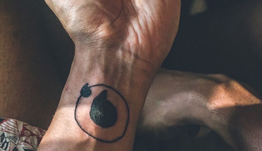 A person with a tattoo of a pear on their wrist.