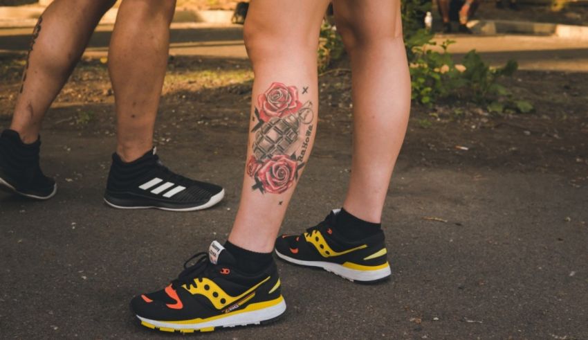 A woman with a tattoo on her leg and a pair of sneakers.