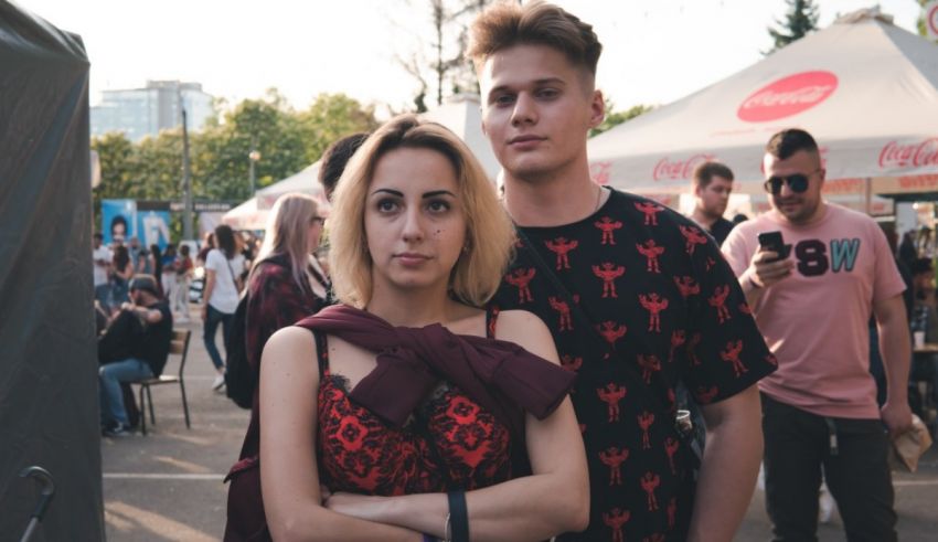 A man and woman standing next to each other at an outdoor event.