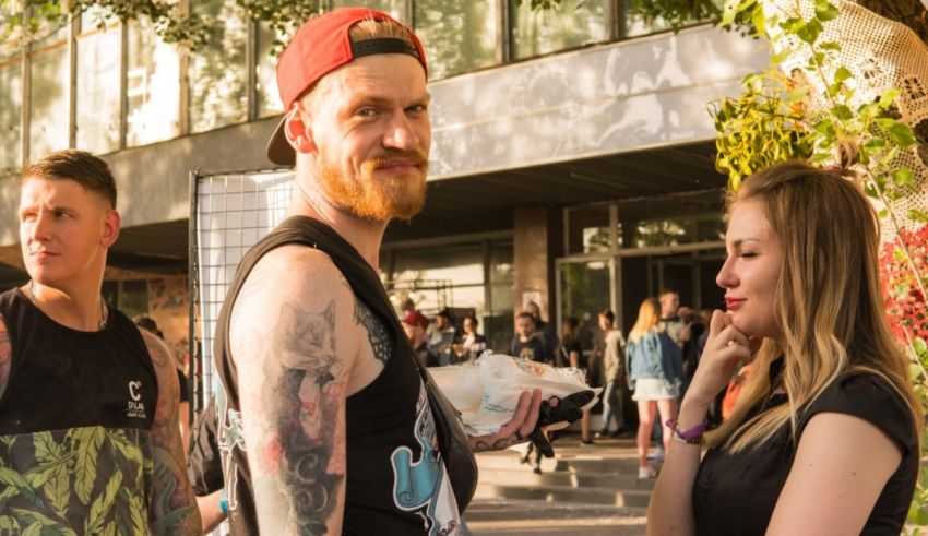 A group of people with tattoos talking to each other.