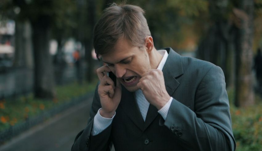 A man in a suit is talking on the phone.