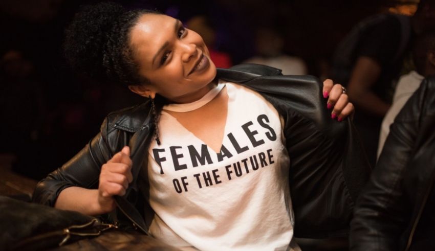 A woman wearing a t - shirt that says females of the future.