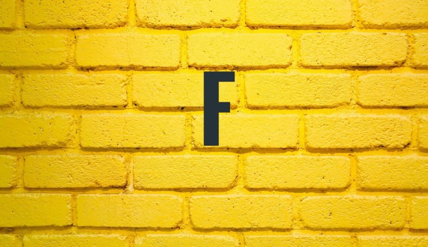 A yellow brick wall with the letter f on it.
