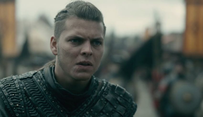 A man in a viking costume is standing in front of a crowd.