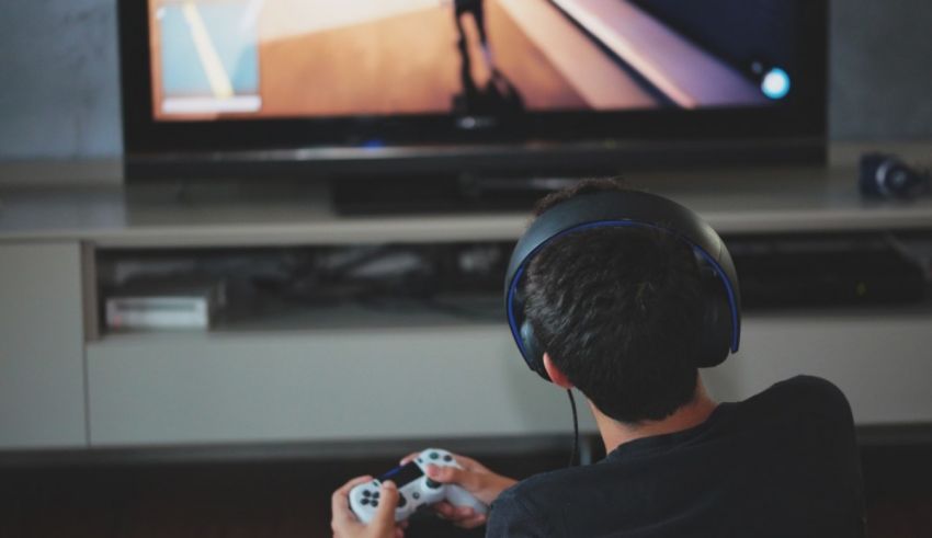 A boy playing a video game in front of a tv.