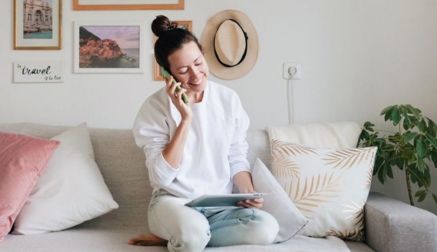 A woman sitting on a couch and talking on the phone.