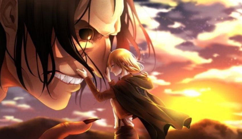 A man and a woman with long hair in front of a sunset.