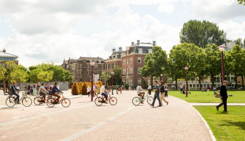 A group of people riding bicycles in a park.