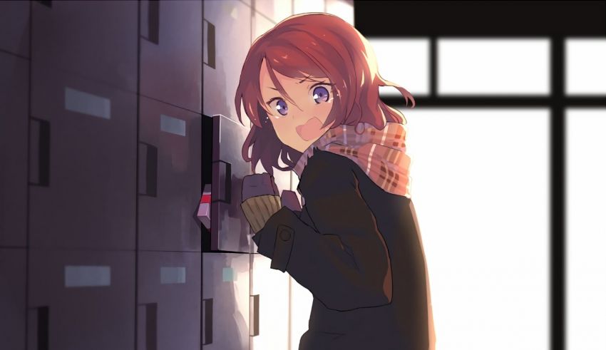 A girl with red hair is standing in front of a locker.