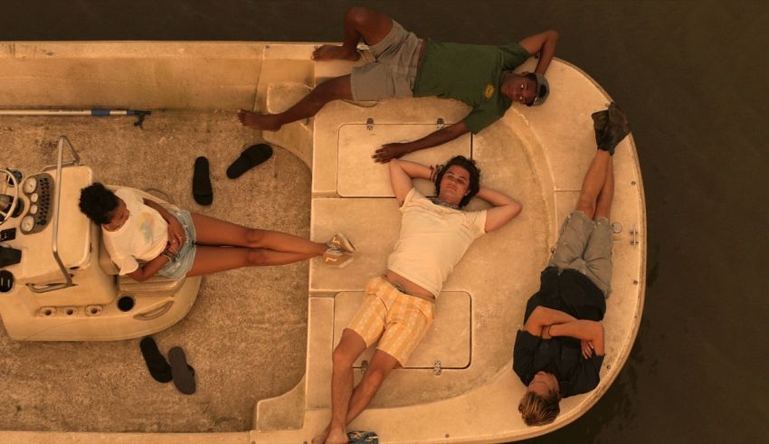 A group of people laying on the back of a boat.