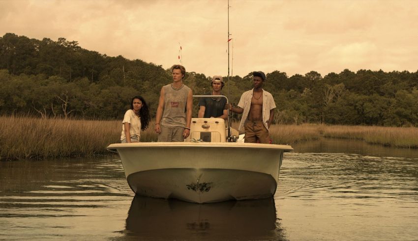 A group of people standing on a boat in the water.