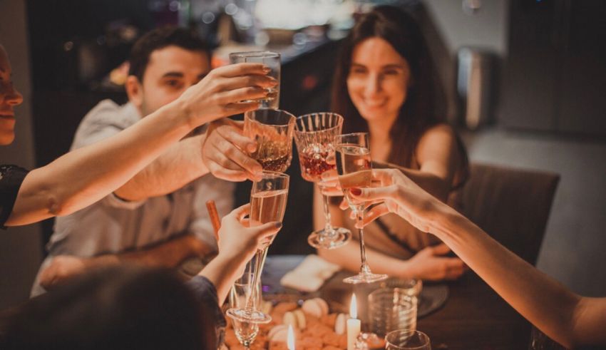 A group of friends toasting wine glasses at a dinner party.