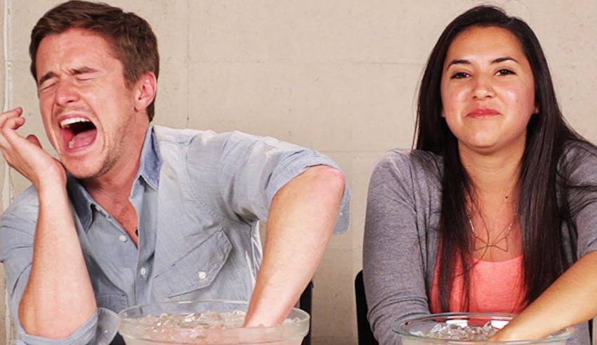 A man and woman are sitting at a table with bowls of ice.