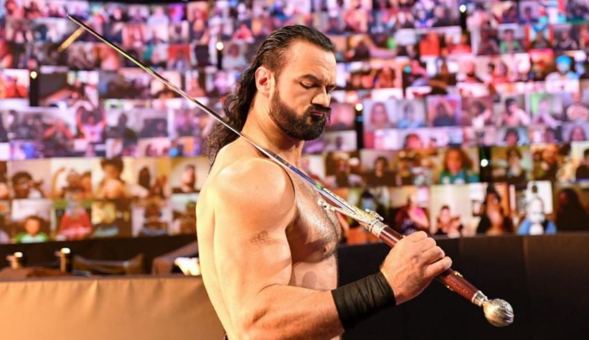 A man holding a sword in front of a crowd.