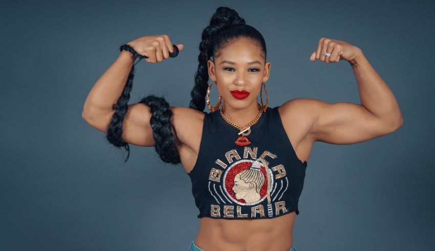 A woman flexing her muscles in front of a blue background.