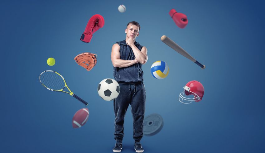 A man standing in front of a group of sports items.